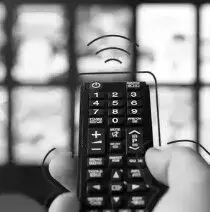 A person holding a remote control in their hand.